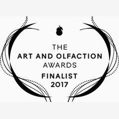 Logo showing "The Art and Olfaction Awards Finalist 2017" with decorative lines, an abstract scent bottle at the top, and a hint of animalistic musks for Civet by Zoologist.