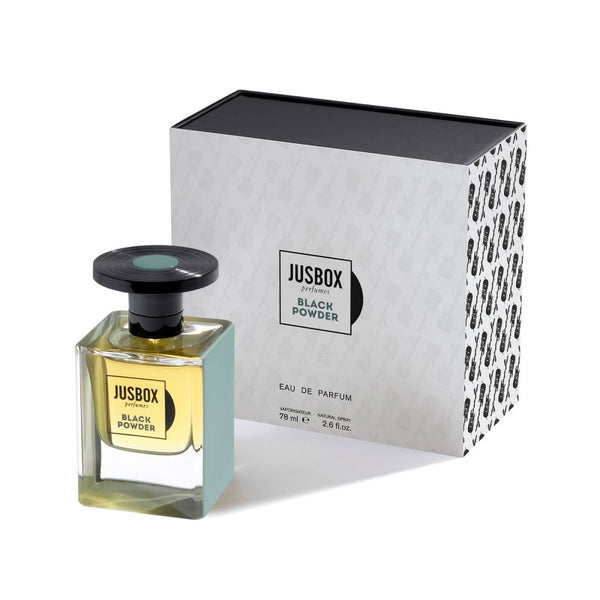 A bottle of Jusbox Black Powder eau de parfum, evoking the spirit of Generation X and the era of Kurt Cobain, is shown next to its branded box. The bottle contains 78ml (2.6 fl. oz.) of this captivating fragrance.