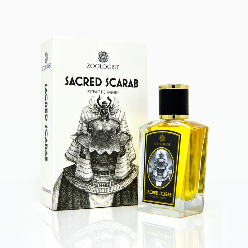 A bottle of Sacred Scarab by Zoologist, showcased beside its box adorned with an illustrated anthropomorphic scarab design, exudes exotic allure with its animalic notes.