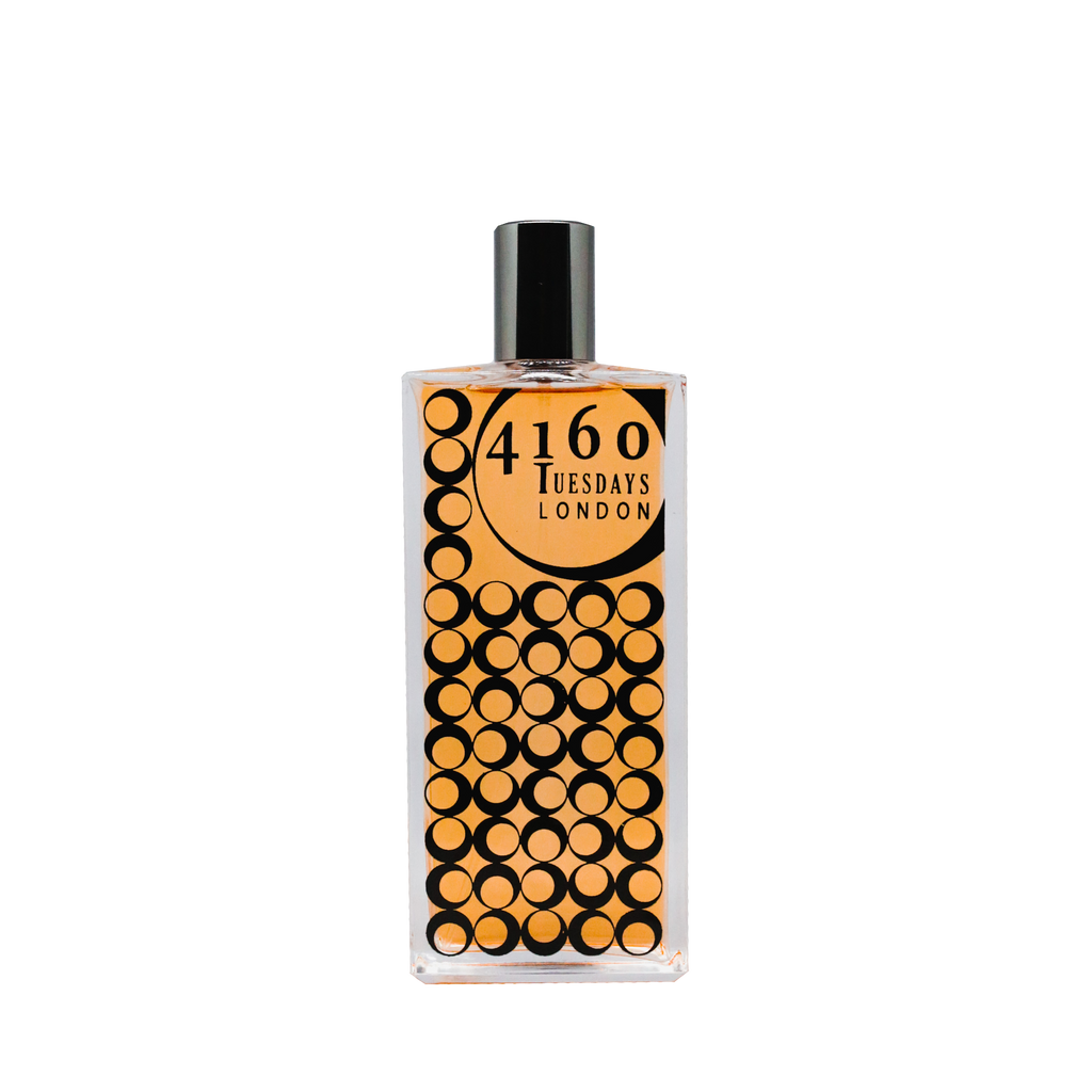 A rectangular perfume bottle labeled "Brackenbury 4160Tuesdays" with a gold and black circular pattern on the front, reminiscent of 1920s elegance. The bottle features a black cap.