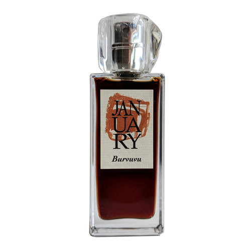 A clear glass perfume bottle labeled "JANUARY" filled with a dark liquid, featuring the brand name "January Scent Project" at the bottom of the label, reveals its identity as Burvuvu Eau de Parfum. This elegant fragrance exudes notes of Cedar and Amber, adding depth to its sophisticated design.