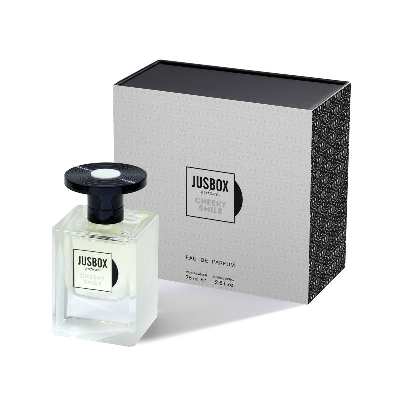 Bottle of Jusbox Cheeky Smile Eau de Parfum, 78ml, exuding the vibrant spirit of Acid House, positioned in front of its sleek black and gray packaging box.