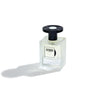 A transparent glass bottle of Jusbox's "Cheeky Smile" perfume, adorned with a sleek black cap, casts a gentle shadow on a pristine white background, radiating the vibrant energy of Acid House through its unique molecular fragrance.