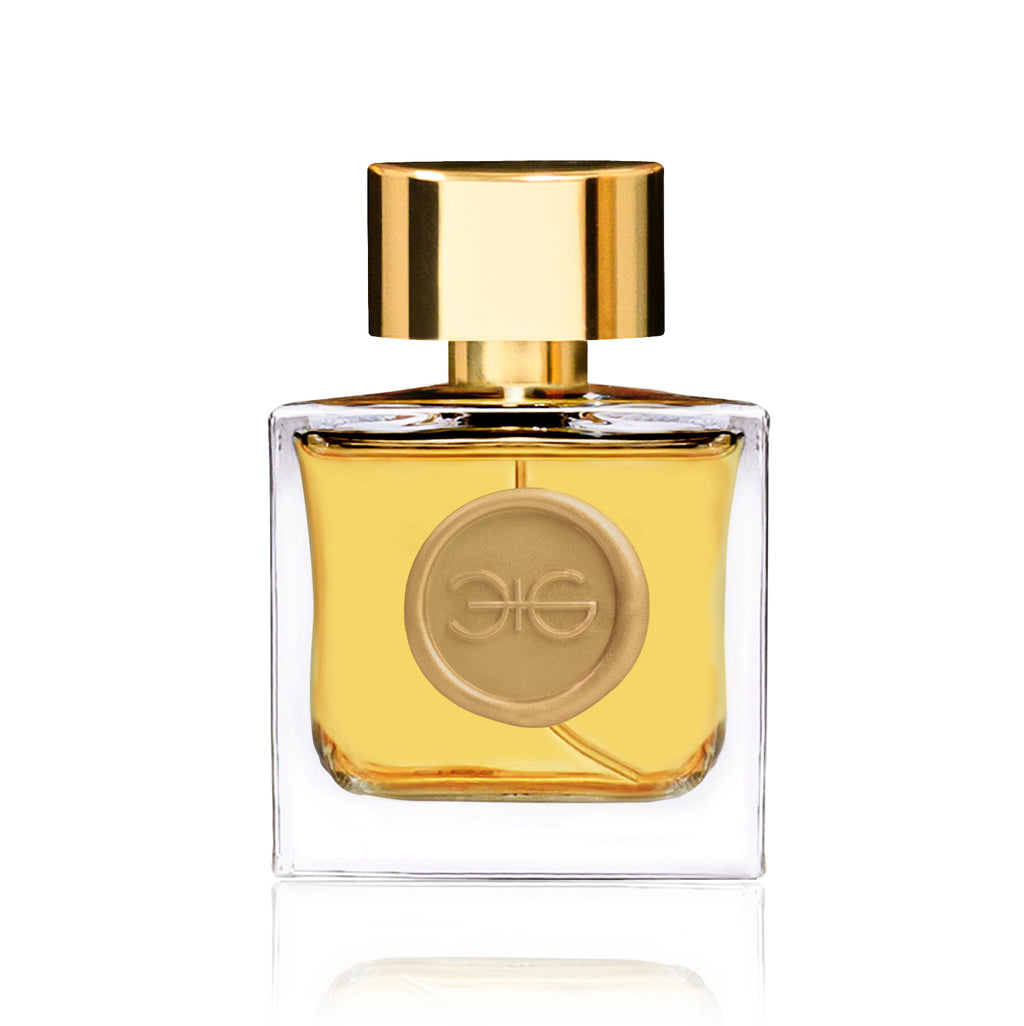 A square glass perfume bottle bearing a gold cap and a golden emblem on the front, filled with a yellowish liquid exuding the essence of CITRINE by Manos Gerakinis, embodying golden energy and empowerment.