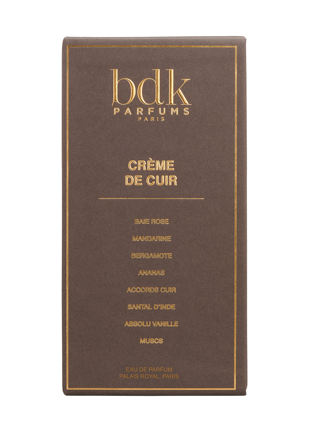 A close-up of a Crème de Cuir perfume box by BDK Parfums showcases gold text detailing the fragrance notes: baie rose, mandarine, bergamote, ananas, accord cuir, santal d'inde, absolu vanille, and muscs. The essence of contemporary sensuality is encapsulated in this exquisite bottle.