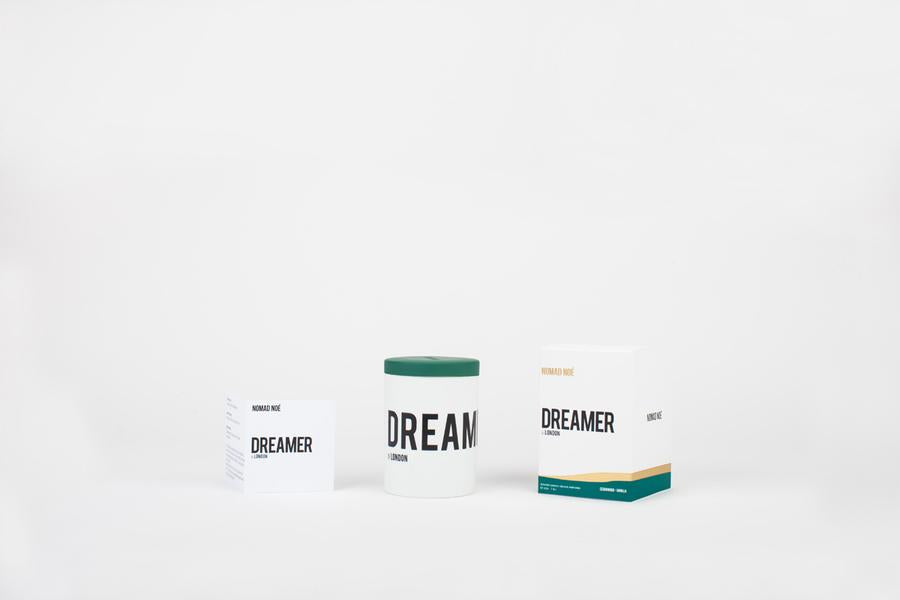 Three product packages are displayed against a plain background: a small rectangular box, a cylindrical container, and a larger rectangular box, all capturing the classic simplicity reminiscent of Aida Overton Walker's vaudeville performances. These products are part of the DREAMER in London collection by Nomad Noe.