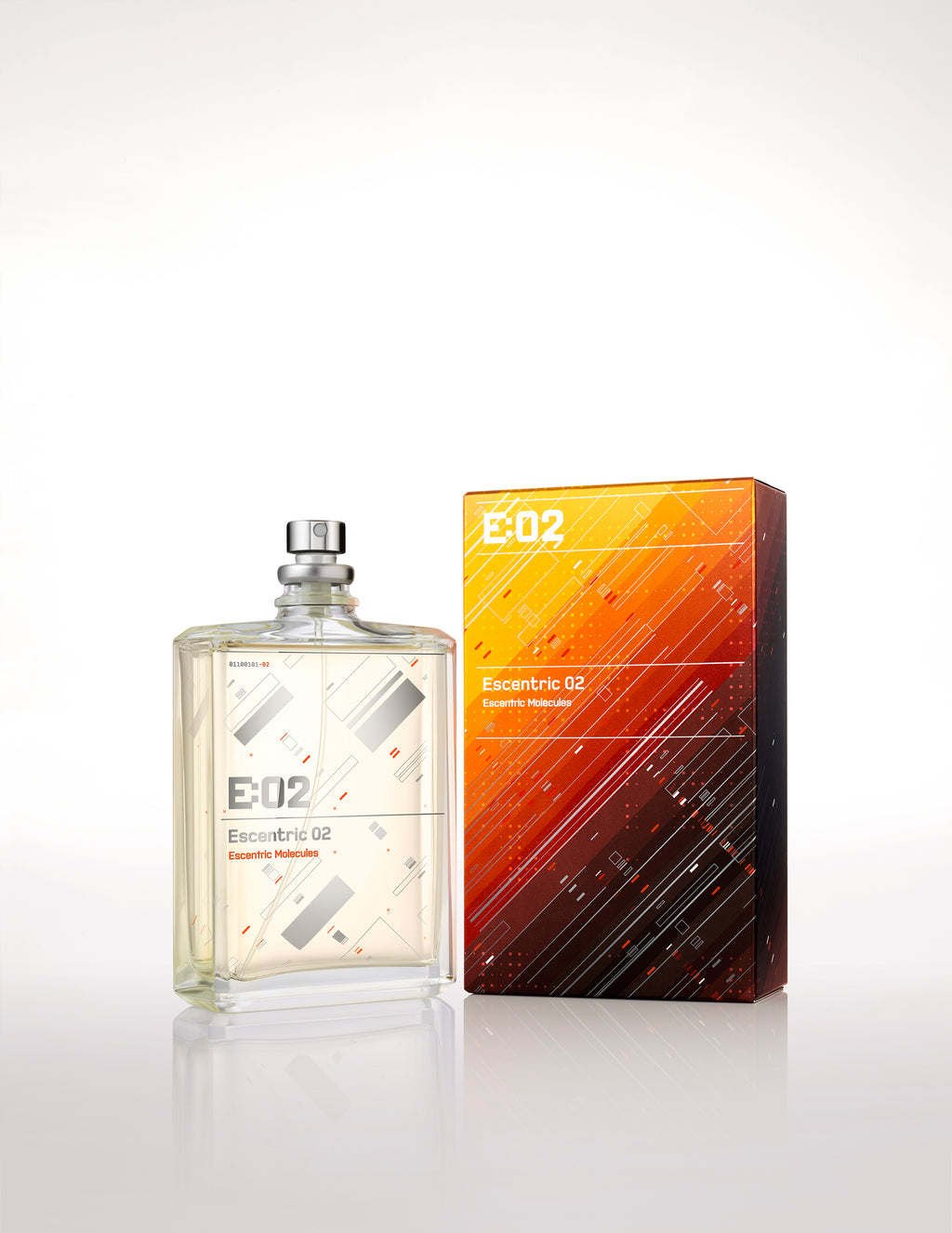 A bottle of Escentric 02 by Escentric Molecules stands next to its rectangular packaging. The bottle is clear with a minimalist design, and the box features an abstract, geometric pattern in warm colors. This fragrance exudes super-longlasting freshness, enriched with the elegance of Ambroxan and hedione.