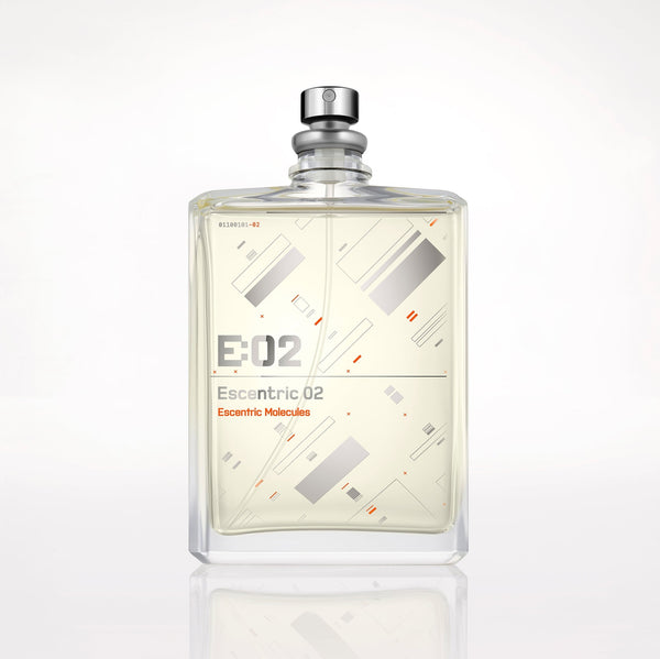 A clear glass bottle of Escentric 02 by Escentric Molecules, featuring geometric designs on the front, a silver spray nozzle on top, and infused with Ambroxan for super-longlasting freshness.
