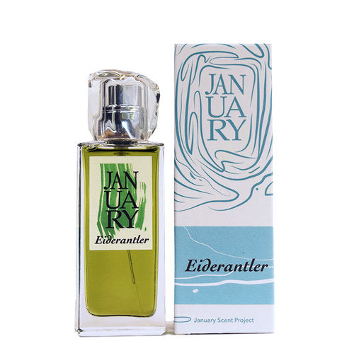 A bottle of "Eiderantler" Eau de Parfum by January Scent Project is placed next to its matching box packaging. The ivy fougère fragrance features green-colored liquid.