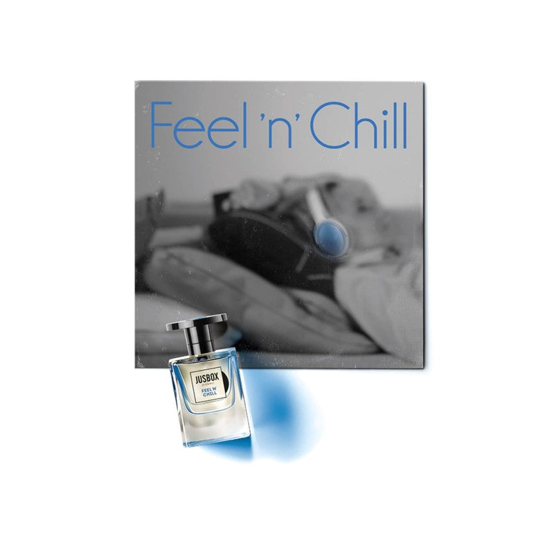 A bottle of Jusbox Feel 'n' Chill fragrance, created by Dominique Ropion, is placed in front of a blurred image of a person lounging. The text Feel 'n' Chill is prominently displayed, emphasizing the aromatherapeutic benefits for ultimate relaxation.
