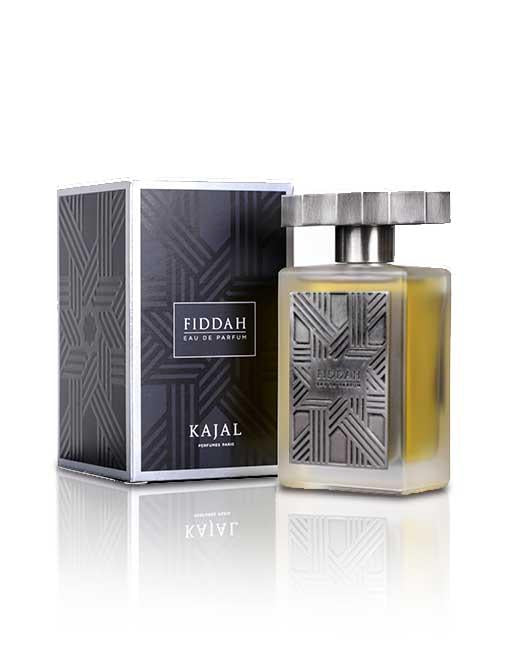 Image of the Fiddah by Kajal - Fiddah Collection fragrance, featuring a rectangular frosted glass bottle with a textured silver cap, placed next to its matching box adorned with geometric designs. The sensual and romantic scent captures smoky leather notes, adding an alluring depth to its elegant presentation.