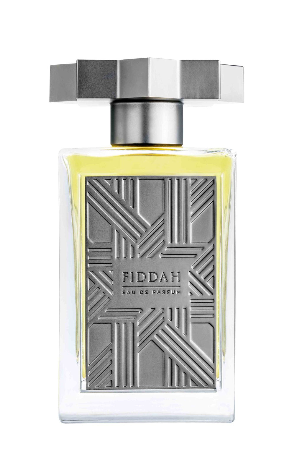 A bottle of Fiddah Eau de Parfum from the Kajal - Fiddah Collection, featuring a translucent container with a geometric-patterned metal front plate and a rectangular metallic cap. This fragrance captures smoky leather scents for a sensual, romantic allure.
