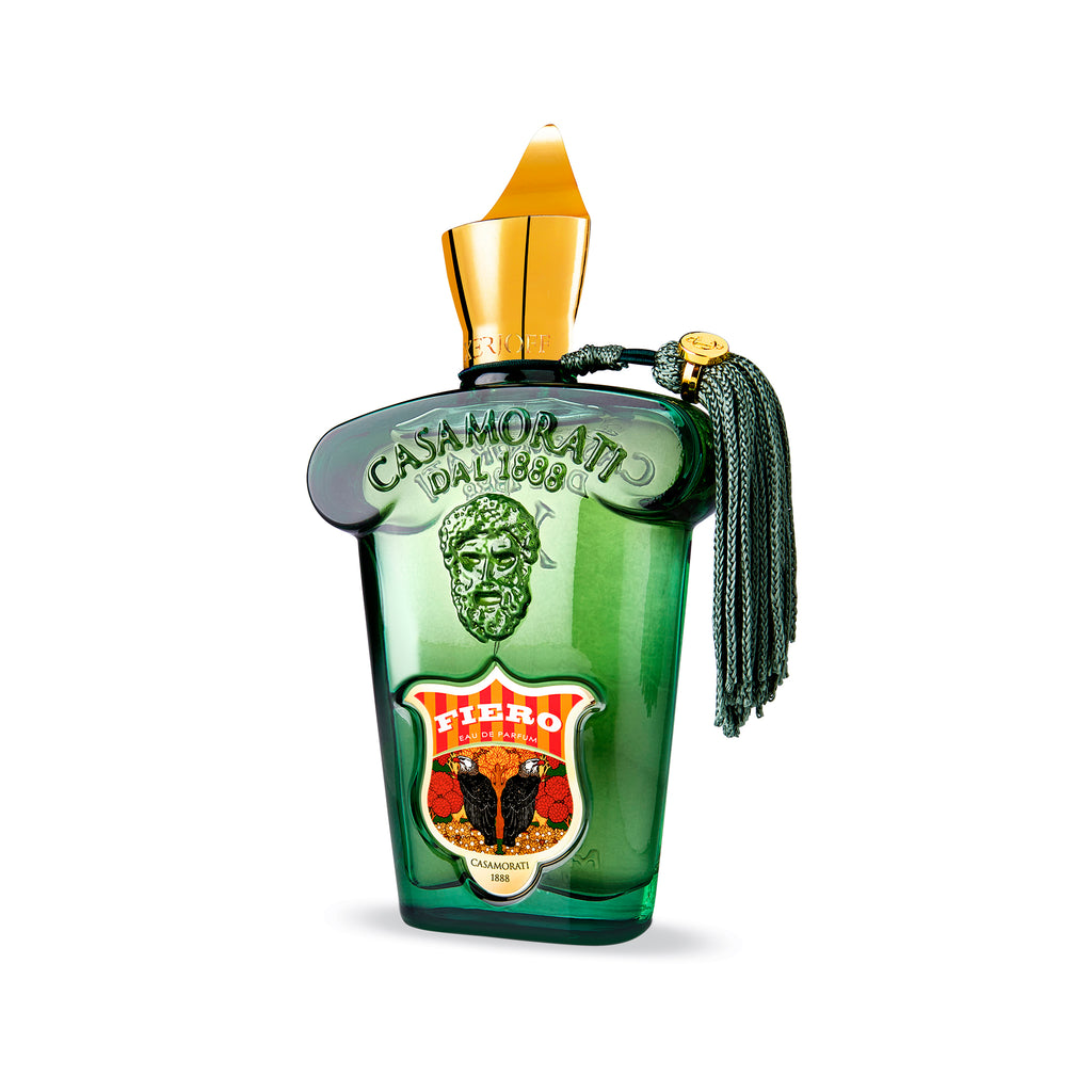 A green glass perfume bottle with gold accents and a tassel, labeled "Casamorati Fiero" with an ornate design, hints at the Casamorati Fiero collection—a masculine powerhouse of sophistication in Eau de Parfum form.