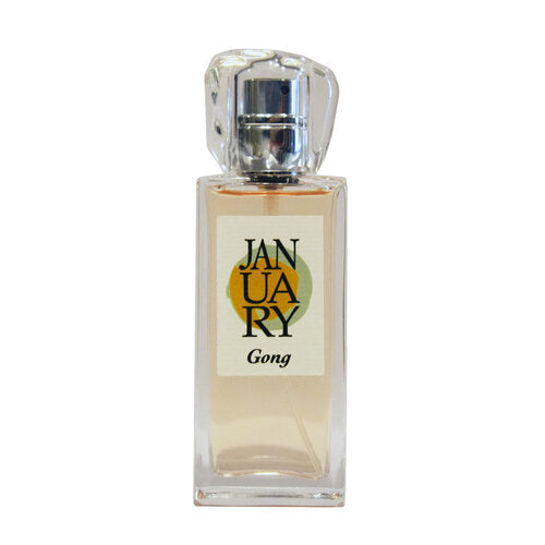 A clear rectangular bottle of "Gong" by January Scent Project, featuring a silver cap and light-colored liquid that exudes subtle notes of Fruit and Green Musk.