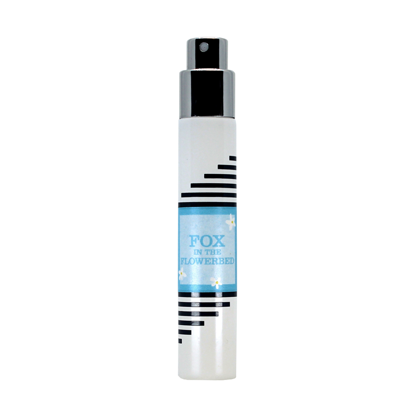A white cylindrical spray bottle featuring black stripes and a blue label that reads "Fox in the Flowerbed" from the brand Imaginary Authors exudes a delightful floral fragrance reminiscent of Chunhua Luli.