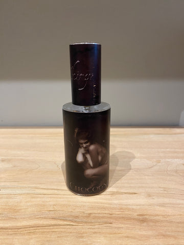 Chocognac fragrance bottle with dark brown cap and cylindrical glass body