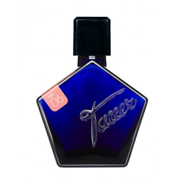 A blue, pentagon-shaped perfume bottle with a black cap, featuring the word "Tauer" embossed on the front and a small red tag labeled "No 06," houses an enchanting Oriental fragrance enriched with hints of frankincense called Incense Rose by Tauer Perfumes.