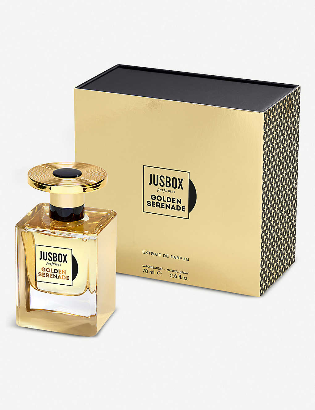 A Jusbox Golden Serenade eau de parfum bottle is showcased in front of its packaging. The gold-colored bottle, adorned with the brand and scent name, suggests the indulgent notes of saffron inside.