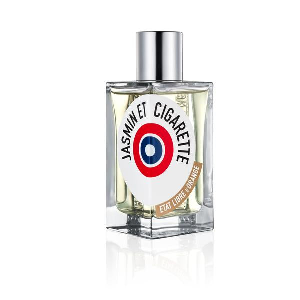 A bottle of perfume labeled "Jasmin Et Cigarette" by État Libre d'Orange featuring a red, white, and blue circular logo with a silver cap evokes the timeless jasmine scent, reminiscent of vintage Hollywood glamour.