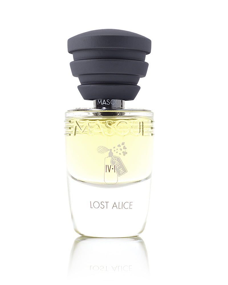 A clear glass perfume bottle labeled "Lost Alice – ACT IV, Scene I" with a black cap and the brand name "Masque Milano" embossed on it. The bottle contains a light yellow liquid, suggesting notes of white roses and black pepper.