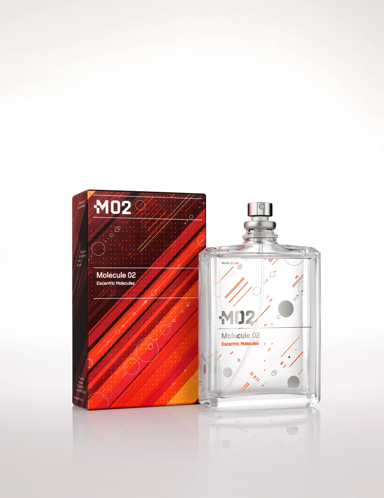 A clear glass bottle labeled "Molecule 02" sits elegantly beside its geometric-patterned box, adorned with "M02" branding and "Escentric Molecules" text. This fragrance showcases Ambroxan, adding a sophisticated touch to its minimalist design.