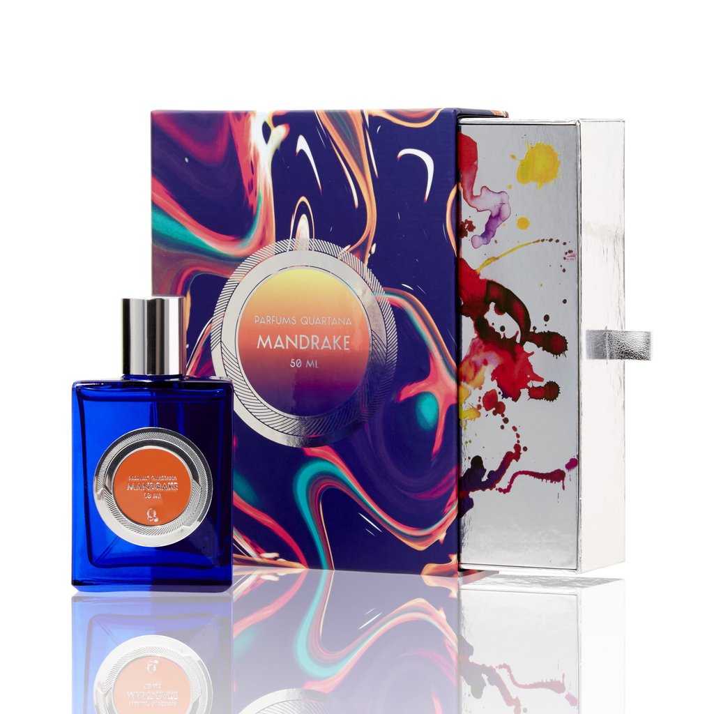 A blue bottle of "Mandrake 50 ml" perfume by Parfums Quartana is displayed beside a colorful, abstractly designed box that hints at the captivating Mandrake Flower Accord scent. The box is partially opened.