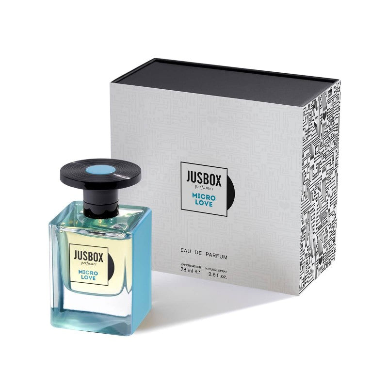 A 78 ml bottle of Jusbox "Micro Love" Eau de Parfum stands beside its rectangular, light grey box adorned with intricate black geometric patterns inspired by the tech designs from the Zoo TV tour.