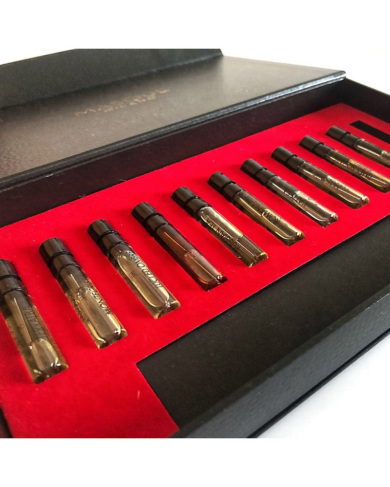 The Masque Milano Opera Collection Discovery Kit from Masque Milano comes in a black case with a red interior, echoing the charm of Hemingway's time in Terralba. It beautifully houses sixteen meticulously labeled 2ml glass vials, each containing an enchanting liquid essence thoughtfully arranged in a single row.