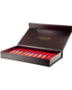 A black box with a red interior from the Masque Milano Opera Collection Discovery Kit contains sixteen 2ml small glass vials labeled with various perfumes, including the evocative "Montecristo," and has "MASQUE MILANO" written on the inside of the lid.