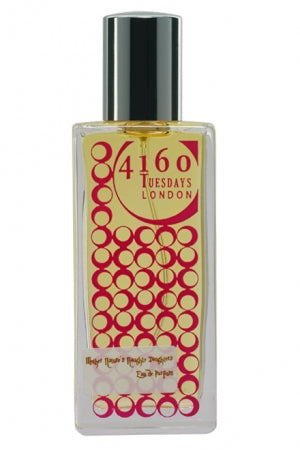 A rectangular perfume bottle labeled "4160Tuesdays" features a yellow and red circular pattern, a black cap, and the luxurious essence of chypre fruity fragrance named "Mother Nature's Naughty Daughters.