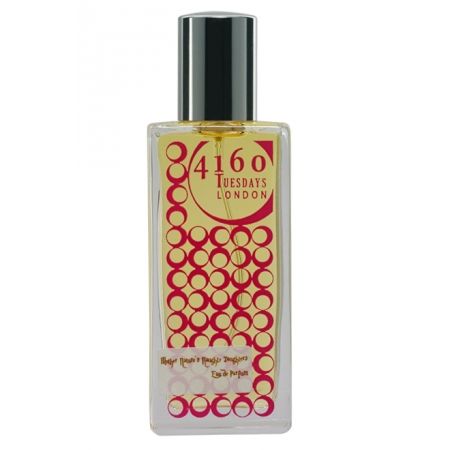 A rectangular perfume bottle labeled "4160Tuesdays" features a yellow and red circular pattern, a black cap, and the luxurious essence of chypre fruity fragrance named "Mother Nature's Naughty Daughters.