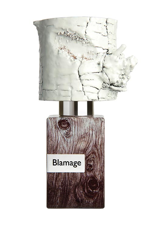 A Nasomatto perfume bottle labeled "Blamage" with a wooden-patterned base and a white, textured cap resembling tree bark.