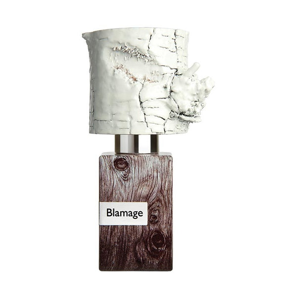 A Nasomatto perfume bottle labeled "Blamage" with a wooden-patterned base and a white, textured cap resembling tree bark.