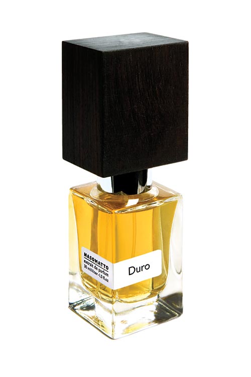 A bottle of Nasomatto's Duro perfume, featuring a black square cap and containing light amber liquid, exudes a sense of male strength.