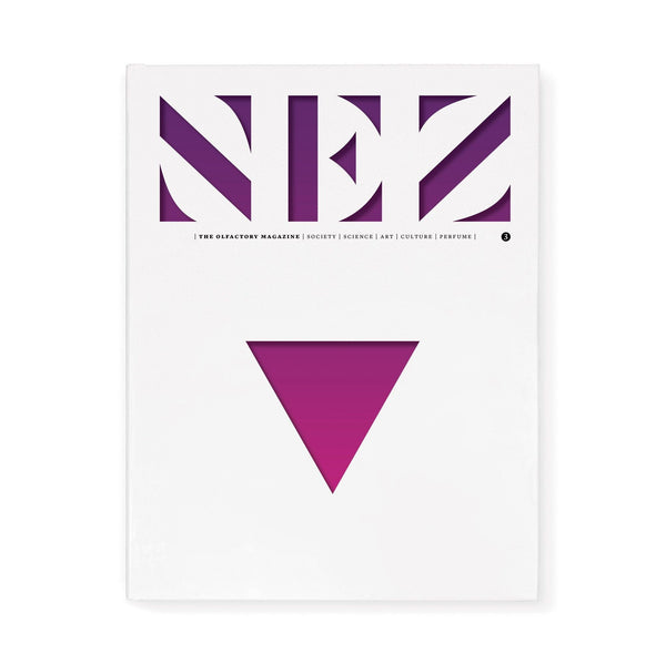 Perfume magazine issue cover with bold purple geometric logo and magenta triangle emblem
