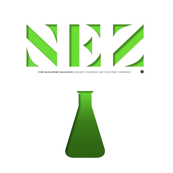 Green perfume bottle illustration on a white magazine page