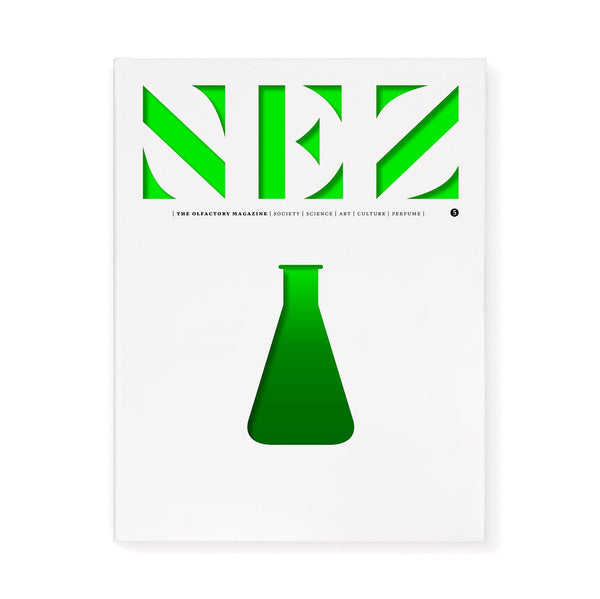 Green perfume bottle illustration on a framed magazine cover page
