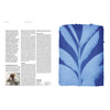Magazine spread with leaf illustration in blue and multiple text columns