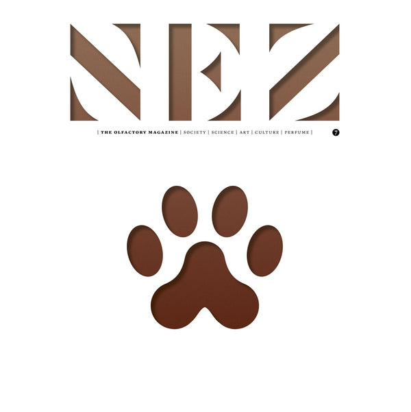 Brown paw print logo on a minimalist magazine page with header lettering.