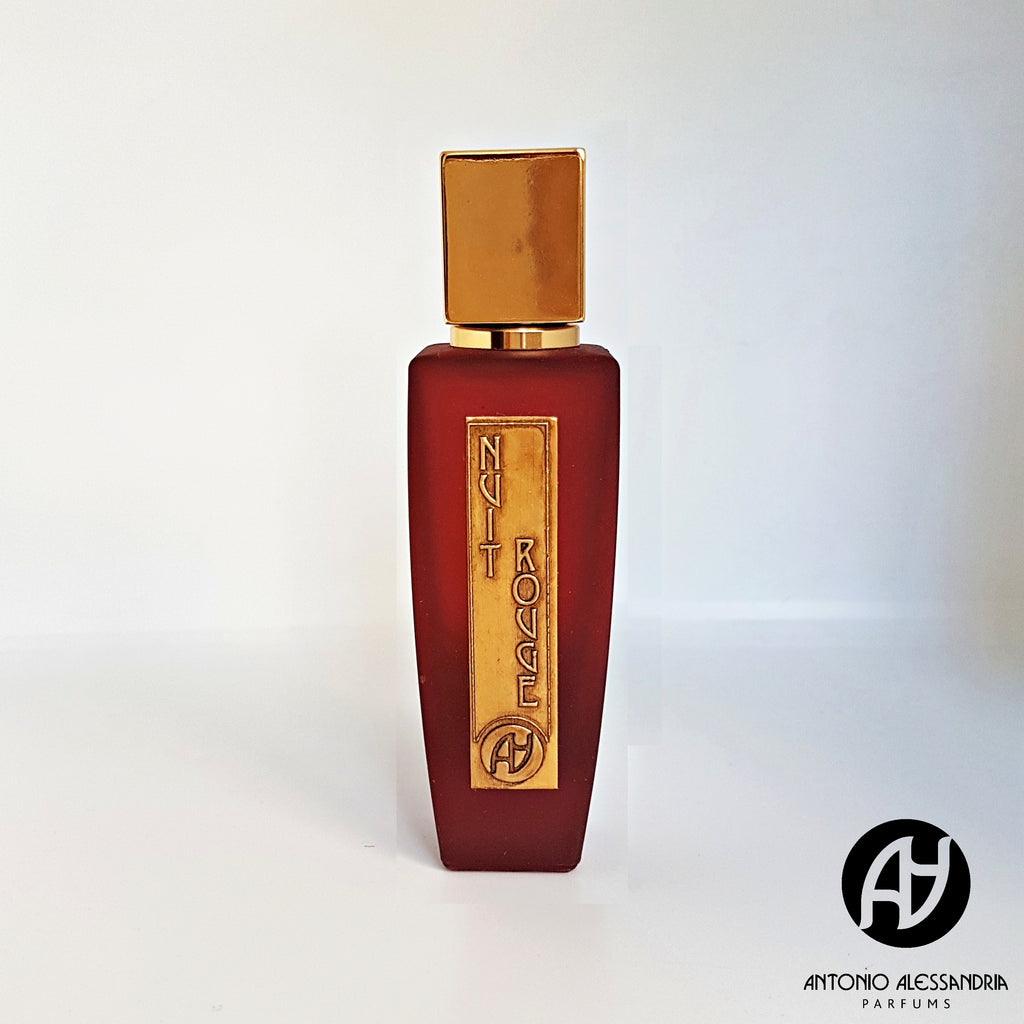 A red perfume bottle with a gold cap and a label reading "Nuit Rouge." The bottom right corner showcases the logo and text "Antonio Alessandria." This luxurious scent features spicy top notes, accentuated by a sophisticated leather scent.