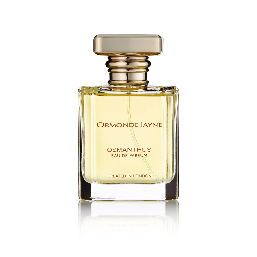 An Ormonde Jayne Osmanthus Eau de Parfum, showcased in a clear glass bottle with a gold cap and label that reads "Created in London," captures the pure essence of Japanese Osmanthus absolute, offering a delicate and refined fruity floral white flower scent.