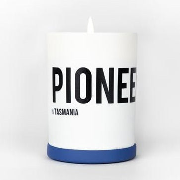 White cylindrical candle with blue base band and PIONEER TASMANIA label