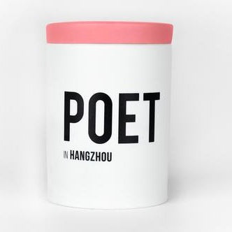 White cylindrical candle with pink lid and POET HANGZHOU label