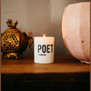 Lit white pillar candle with pink band and POET HANGZHOU label