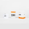 REBEL Bahia candle set: white jars with orange tops and an orange-accent box