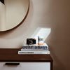 REBEL Bahia candle jar with orange lid on books, with matching candle package