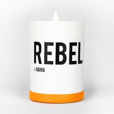 REBEL Bahia candle in white glass with orange base and black logo text