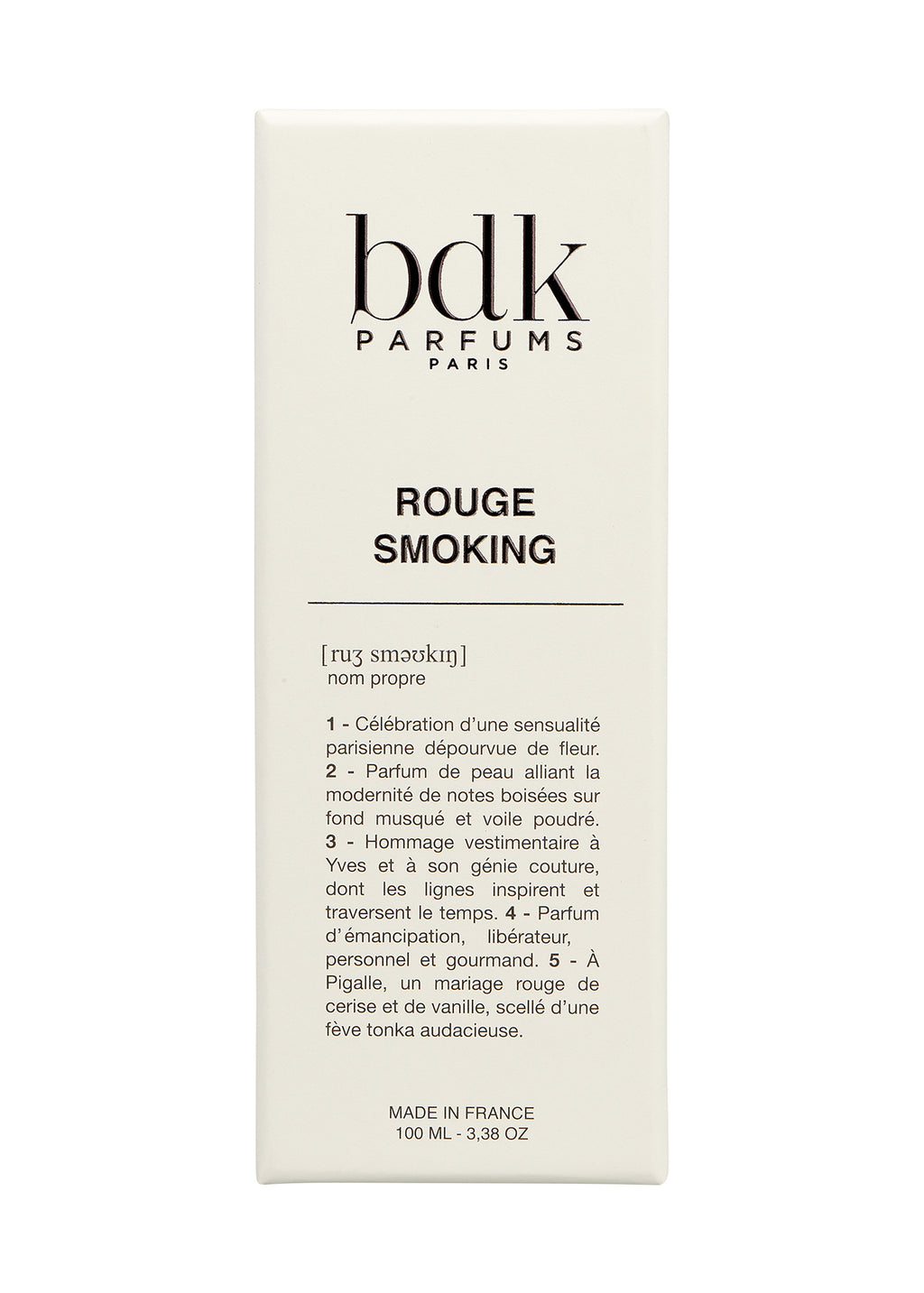 A bottle of BDK Parfums Rouge Smoking, 100 mL, radiates Parisian glam. The label features detailed descriptions in French. Made in France.