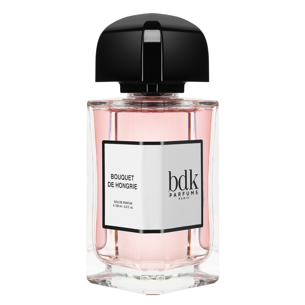 A clear bottle of BDK Parfums Bouquet de Hongrie, featuring pink liquid that pairs elegantly with a black cap and a label displaying the perfume name and volume. The fragrance highlights notes of Turkish Rose, perfect for complementing your favorite nude lipstick.