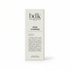 A white packaging box with the brand name "BDK Parfums" and the fragrance name "Gris Charnel" printed on it, enhanced by descriptive text in French. It evokes serene strolls through Jardin des Plantes and hints of sandalwood from India.